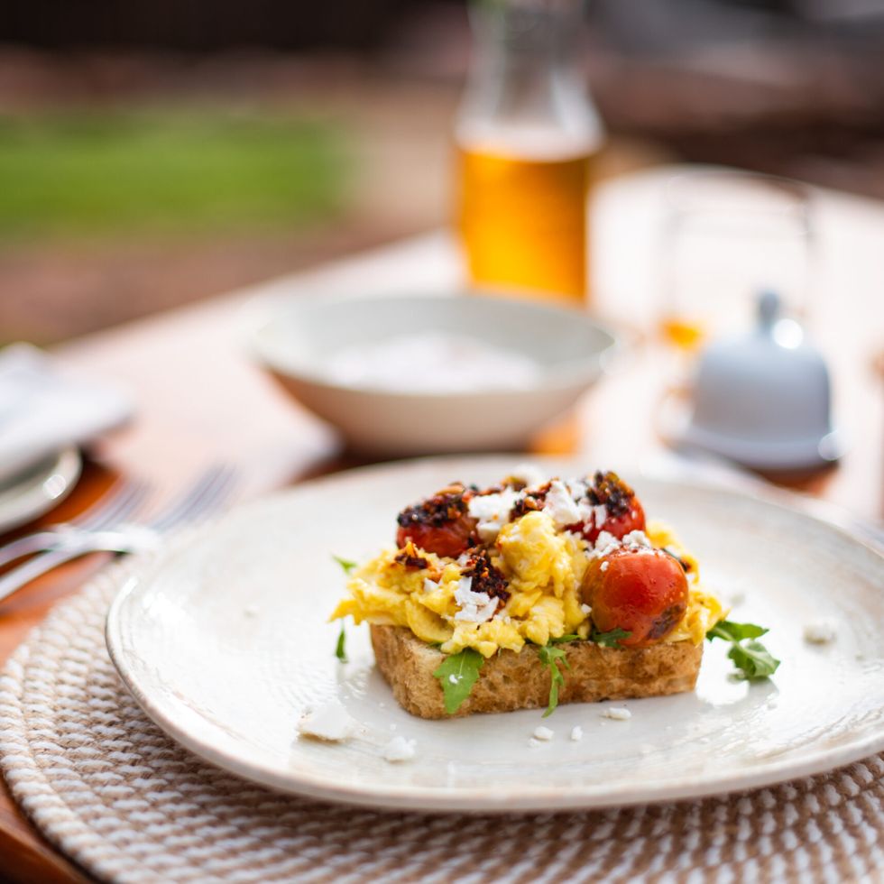 Scrambled egg, roasted cherry tomato, feta & basil pesto on toasted sourdough at Ekuthuleni Lodge, Welgevonden Game Reserve